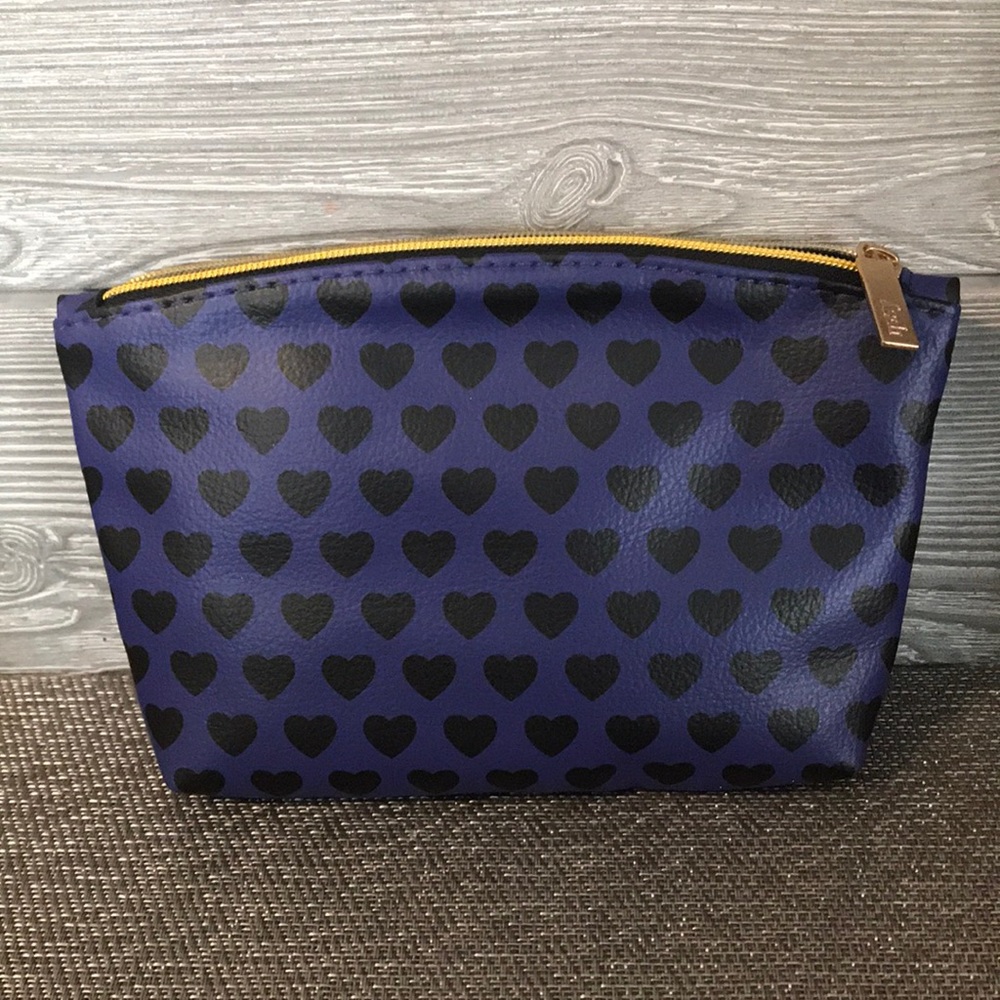 Purple makeup bag with black hearts and gold zip